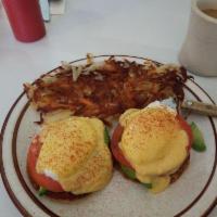 Eggs Benedict · 2 poached eggs and Canadian bacon atop a grilled English muffin topped with hollandaise sauce.