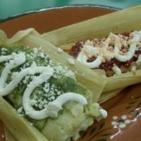 Tamales · 2 pieces. Corn based dough wrapped in a leaf paper and filled with 1 beef and 1 cheese and g...