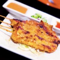 Satay Chicken · Marinated in coconut milk and a medley of spices served on skewers with peanut sauce and cuc...