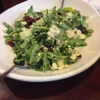 Blue Apple Salad · Arugula, chopped green apples, and dried cranberries topped with gorgonzola and blue cheese ...