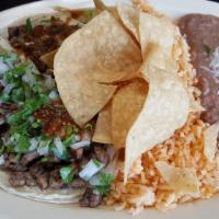 Soft Taco Dinner Plate · 3 tacos choice of meat,onions, cilantro, red salsa, served with rice and beans.