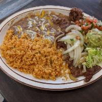 Carne Asada · Tender sliced Steak marinated in spices and charbroiled. Topped with grilled onions and serv...