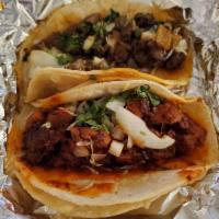 Mexican Taco Combo · Pork marinated in red chili sauce then grilled to perfection. Garnished with chopped onions,...