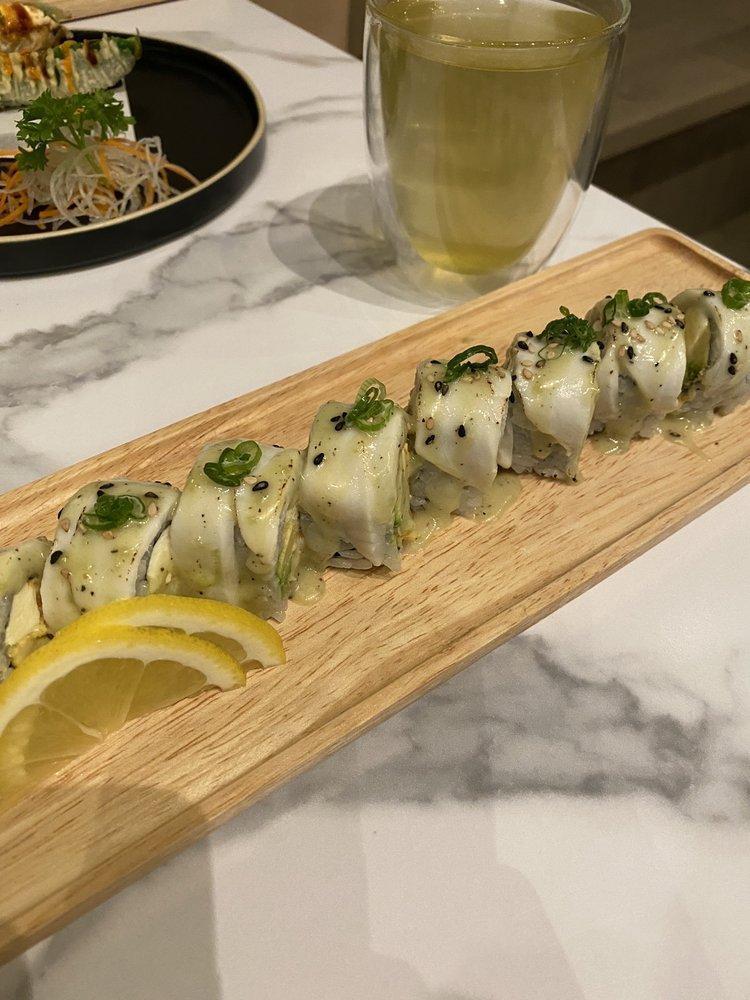 Snow White Roll · Spicy shrimp, cream cheese, avocado inside, torched white tuna on top with green onion wasabi mayo.