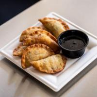Gyoza · Six fried pork dumplings filled with meat, vegetables, and spices. Served with house made gy...