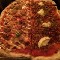 Spicy Chicken Sausage Pizza · Tomato sauce, balsamic onions, TE signature ground chicken sausage and herbed ricotta.