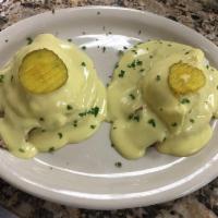 Cuban Eggs Benedict · Poached eggs on English muffin. Served with shredded beef or pulled pork. Topped with hollan...