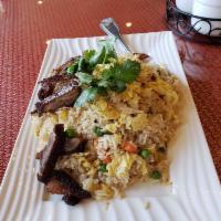 Crab Fried Rice · Fresh Dungeness crab meat is stir-fried with jasmine rice, egg, pea and carrot.
