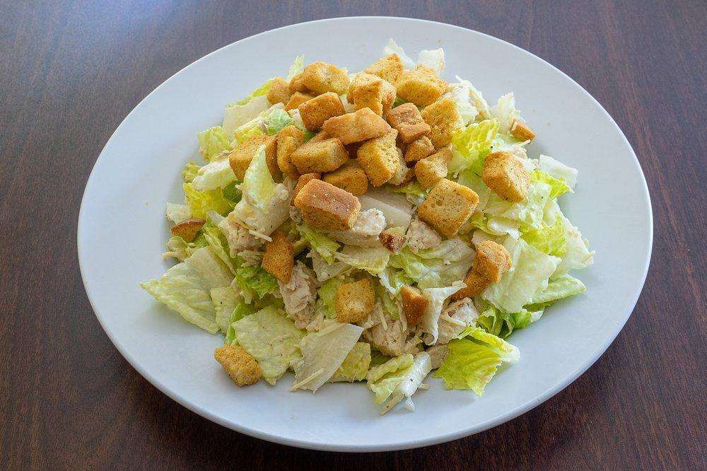 Chicken Caesar Salad · Romaine Lettuce, Parmesan & Croutons tossed in creamy Caesar Dressing.