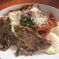 Chilaquiles · Homemade chips smothered in red or green salsa topped with sour cream and queso fresco. Serv...