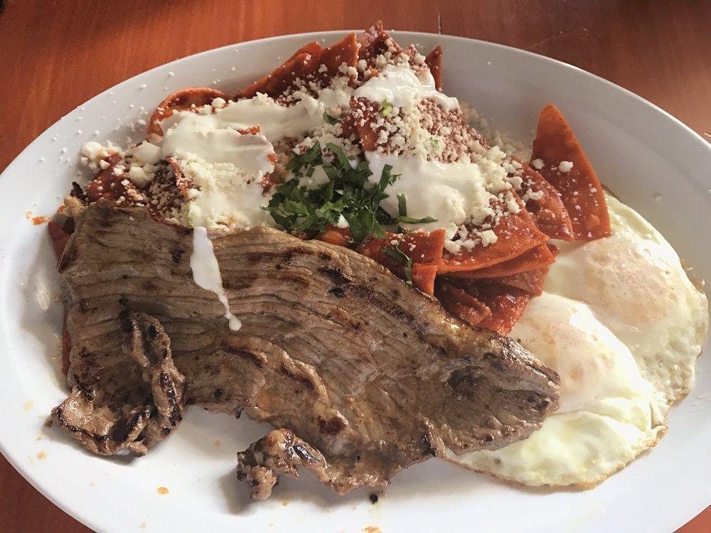 Chilaquiles · Homemade chips smothered in red or green salsa topped with sour cream and queso fresco. Served with rice and beans. Add rice and beans for an additional charge.