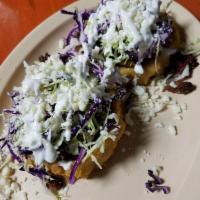 Sopes · Topped with refried beans, cabbage, queso fresco, sour cream and pico de gallo.