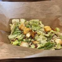 Caesar Salad · Romaine, Caesar dressing, Parmigiano Reggiano, crispy bacon and croutons. Add chicken for an...