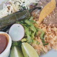 Carne Asada · Marinated and grilled hanger steak served with a cheese enchilada, charred baby onions and g...