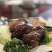 Lao Sausage · Ground pork, shallot, garlic, lemongrass, kaffir lime leaves, black pepper and chili peppers.