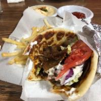 Lamb and Steak Gyro · Thin marinated slices of lamb and steak topped with fresh lettuce, onions, tomatoes, and tza...