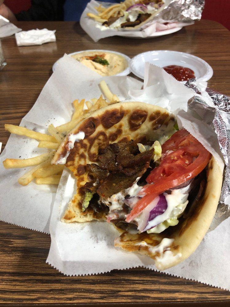 Lamb and Steak Gyro · Thin marinated slices of lamb and steak topped with fresh lettuce, onions, tomatoes, and tzatziki sauce (cucumber sauce), and hummus served on a hot pita bread.