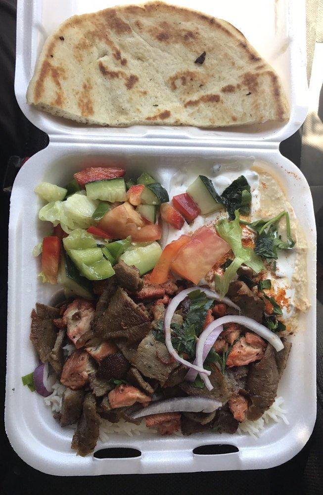 Combination Plate · Thin marinated slices of lamb, steak with chicken over basmati rice served with a side of salad, side of hummus, side of tzatziki sauce (cucumber sauce) and hot piece of pita bread.