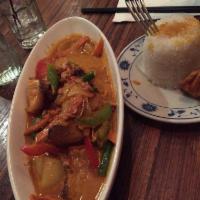 Red Curry · Thai spices blended in chili paste with bamboo shoots, basil, and bell peppers simmered in c...