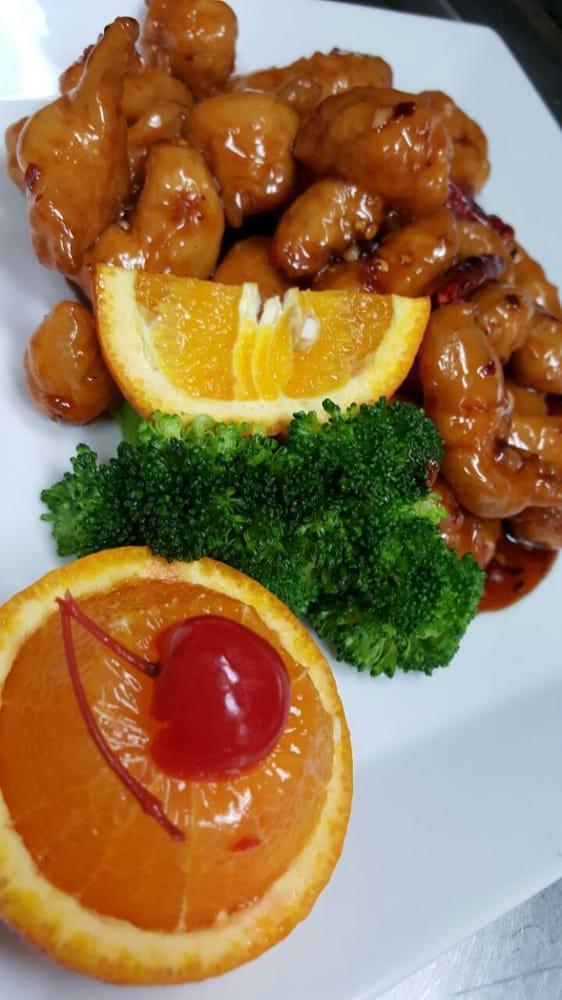 Orange Chicken · Fried golden brown chicken tossed in spicy orange sauce. Served with broccoli. Served with rice. Hot and spicy.