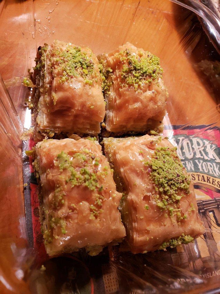 Baklava · Sweet pastry made of extremely thin sheets of phyllo dough, layered with chopped nuts and honey syrup, backed with butter and cut into diamonds. 