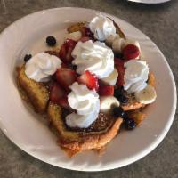 French Toast · Served with choice of fresh strawberries, cinnamon apples, blueberries, or peaches. Dusted w...
