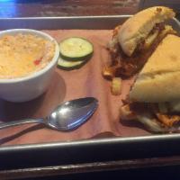 Sliced Brisket Sandwich · Sliced brisket with signature sauce topped with melted provolone cheese, pickled onions serv...