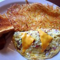 El Camino Real Omelette · Made with 3 eggs, bacon, ham, mushrooms, onions and American cheese and served with choice o...