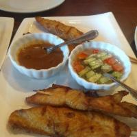 Chicken Satay · Grilled tender strips of chicken breast on bamboo skewers, and served with peanut sauce and ...