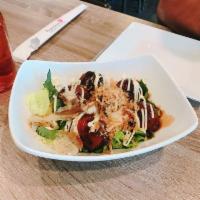 Takoyaki · Fried octopus d
umplings drizzled with Japanese mayonnaise, katsu sauce and sprinkled with b...