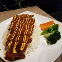 Chicken Katsu · Breaded chicken cutlet served over a bed of steamed rice and coleslaw on the side, drizzled ...