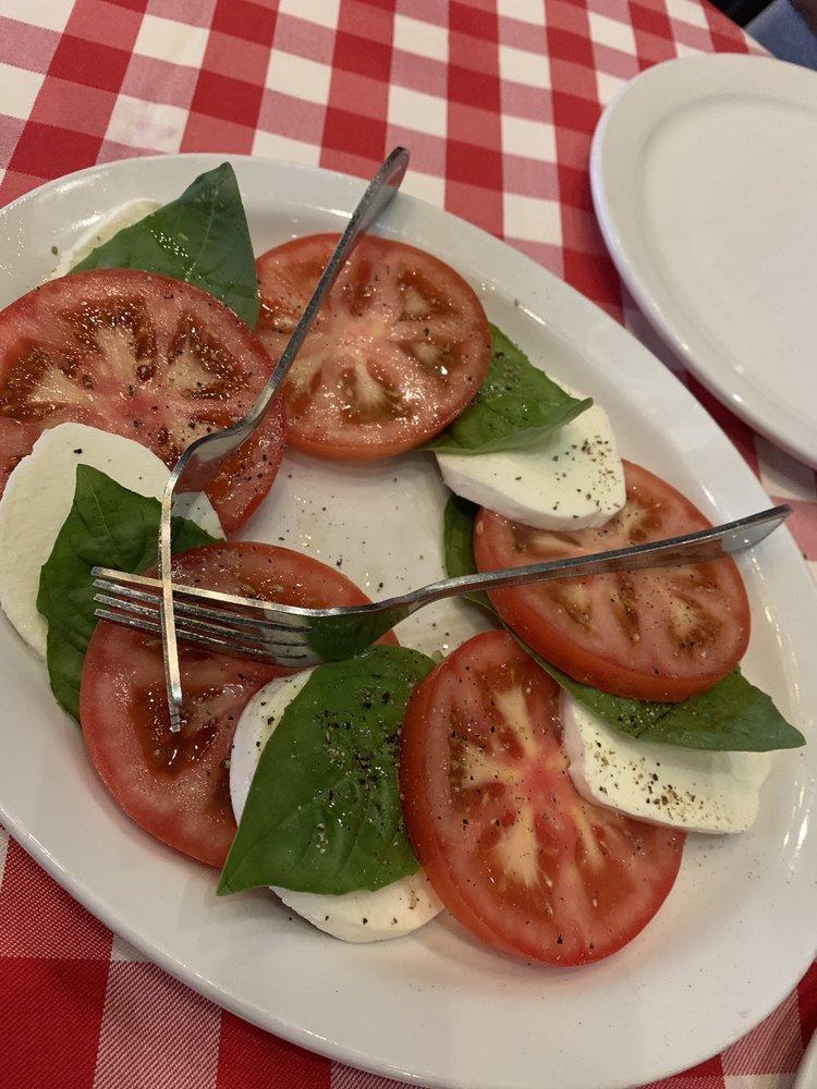 Caprese Salad · Slices of fresh mozzarella, tomatoes and fresh basil, drizzled with extra virgin olive oil.