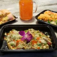 Paradise Roll · Spicy lobster salad, shrimp, banana tempura, radish sprouts, soy paper wrap and yuzu mango s...
