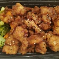 Sesame Chicken · Tempura-battered chicken sauteed in sweet and tangy sauce, topped with sesame seeds, and a s...