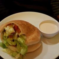Falafel Sandwich · Fresh pita pocket stuffed with fried falafel and house salad. Served with a side of tahini s...