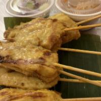 Chicken Satay · Grilled marinated chicken served with peanut sauce and cucumber salad.