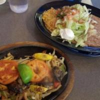 Fajitas · Grilled steak, chicken or shrimp served on a sizzling skillet with onions and bell peppers. ...