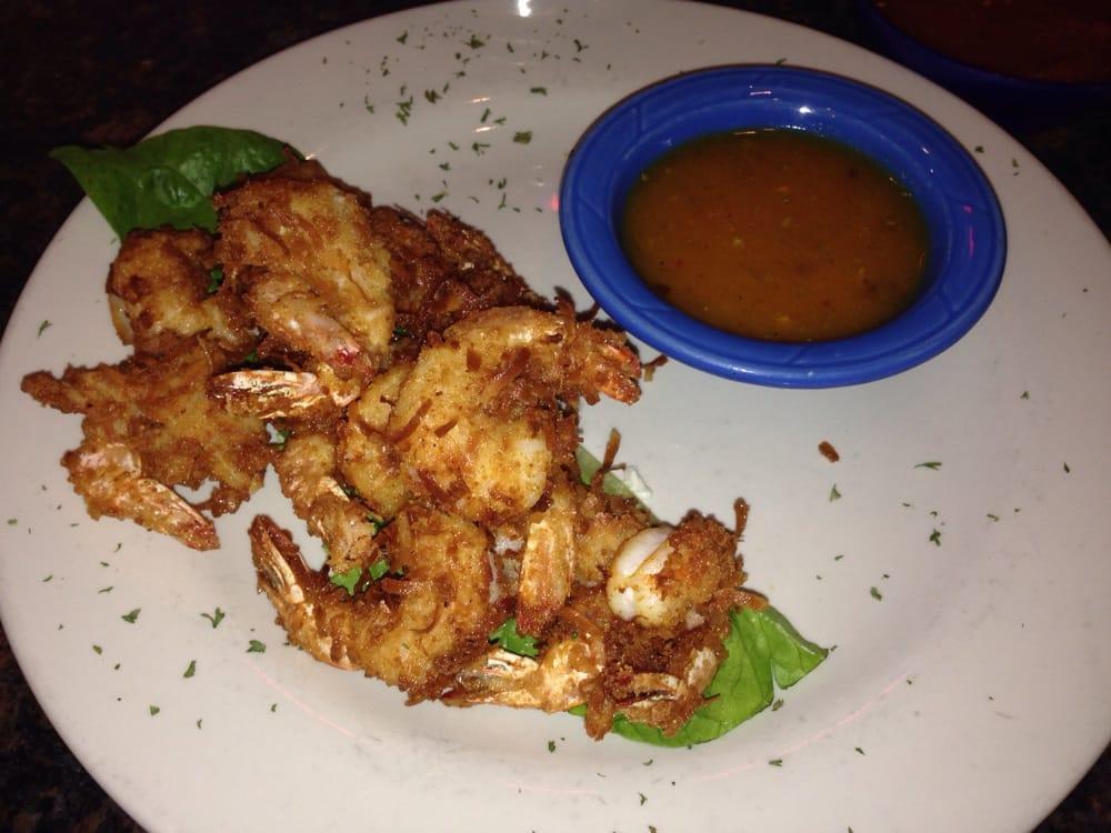 Coconut Shrimp · 12 crispy shrimp breaded with sweet coconut and served with a homemade pina colada dip.