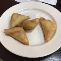 Veggie Samosas · Order of 6 pan-fried pastry shells filled with potatoes, green peas and spices, served with ...