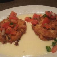 Crab Cakes · 2 lamp crab cakes in a white wine cream sauce. Topped with pico de gallo.