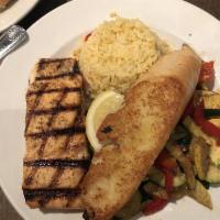 Grilled Salmon · Served with lemon, garlic butter with rice pilaf and julienned vegetables.