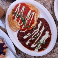 Huevos Rancheros ·  Two Eggs Over Easy, Pepper Jack Cheese & Corn Tortillas, Topped With Our Spicy Ranchero Sau...