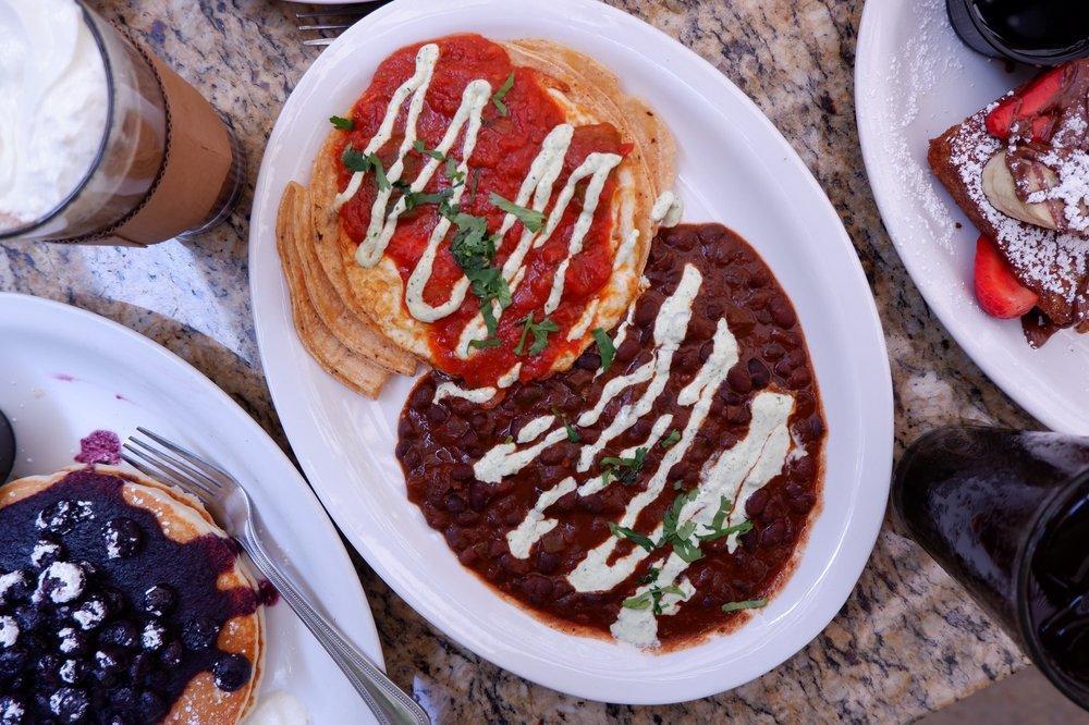 Huevos Rancheros ·  Two Eggs Over Easy, Pepper Jack Cheese & Corn Tortillas, Topped With Our Spicy Ranchero Sauce, Served With Black Bean Chili & Jalapeño Sour Cream