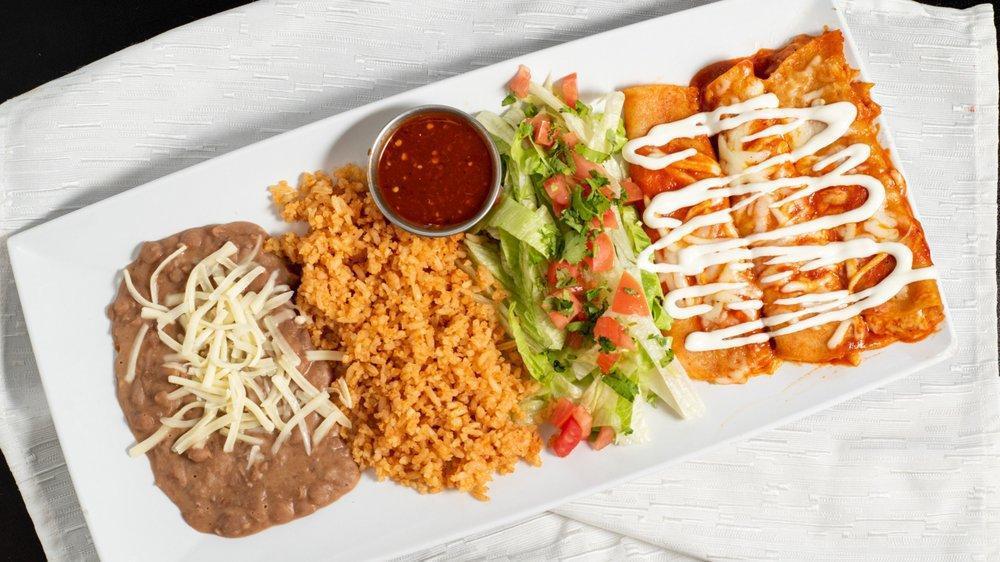 Enchiladas Plate · 3 enchiladas, your choice of meat, Monterey cheese, mom's signature red mole sauce topped with sour cream.

