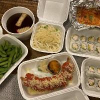 Tiger Roll · Shrimp tempura, crabmeat and avocado on the inside and spicy tuna on the outside.