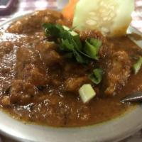 Chicken Curry · Traditional poultry dish prepared in a spicy curry sauce of ground onions, garlic, ginger, t...