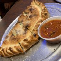 Calzone · Thin pizza dough stuffed with your choice of 2 pizza toppings, ricotta cheese, herbs, and mo...