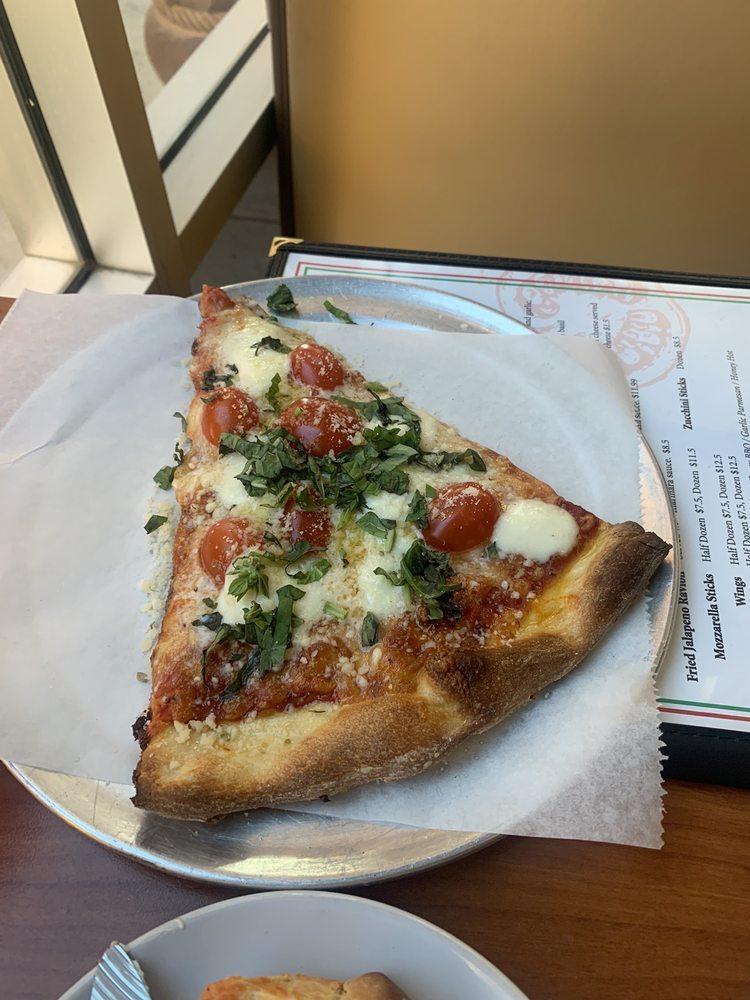 Margherita Pizza · Topped with tomatoes, fresh mozzarella and fresh basil drizzled with extra virgin olive oil.