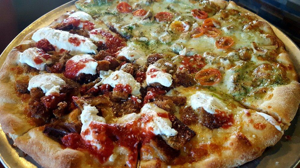 Pesto Chicken Pizza · Basil pesto with grilled chicken, mozzarella cheese, and tomatoes topped with fresh mozzarella.