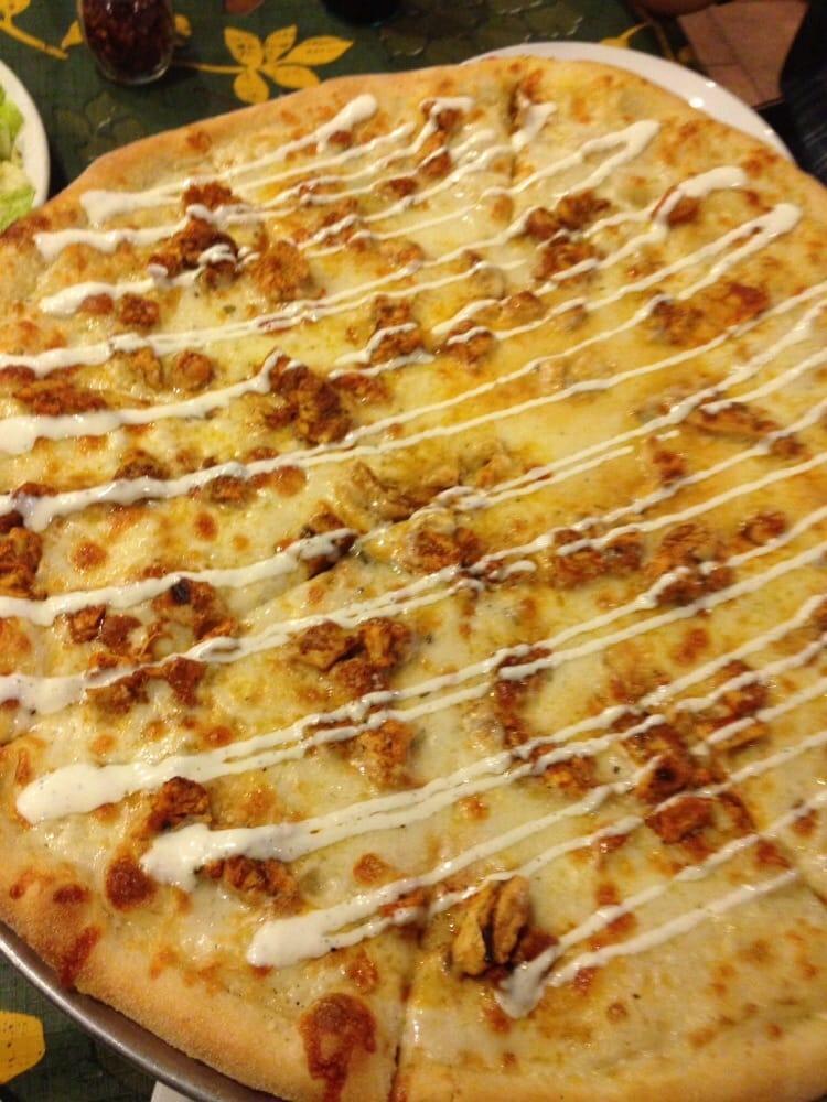Buffalo Chicken Pizza · Bleu cheese dressing brushed on our freshly made pizza dough with grilled chicken tossed in a spicy wing sauce and drizzled with ranch dressing.